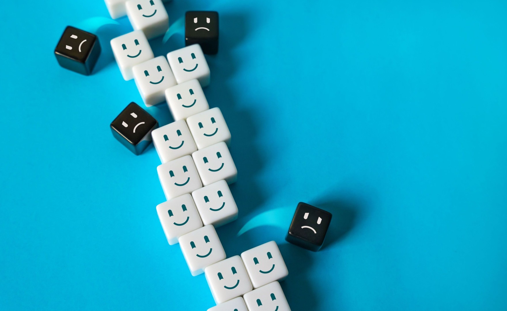 Image of dice with happy and unhappy faces