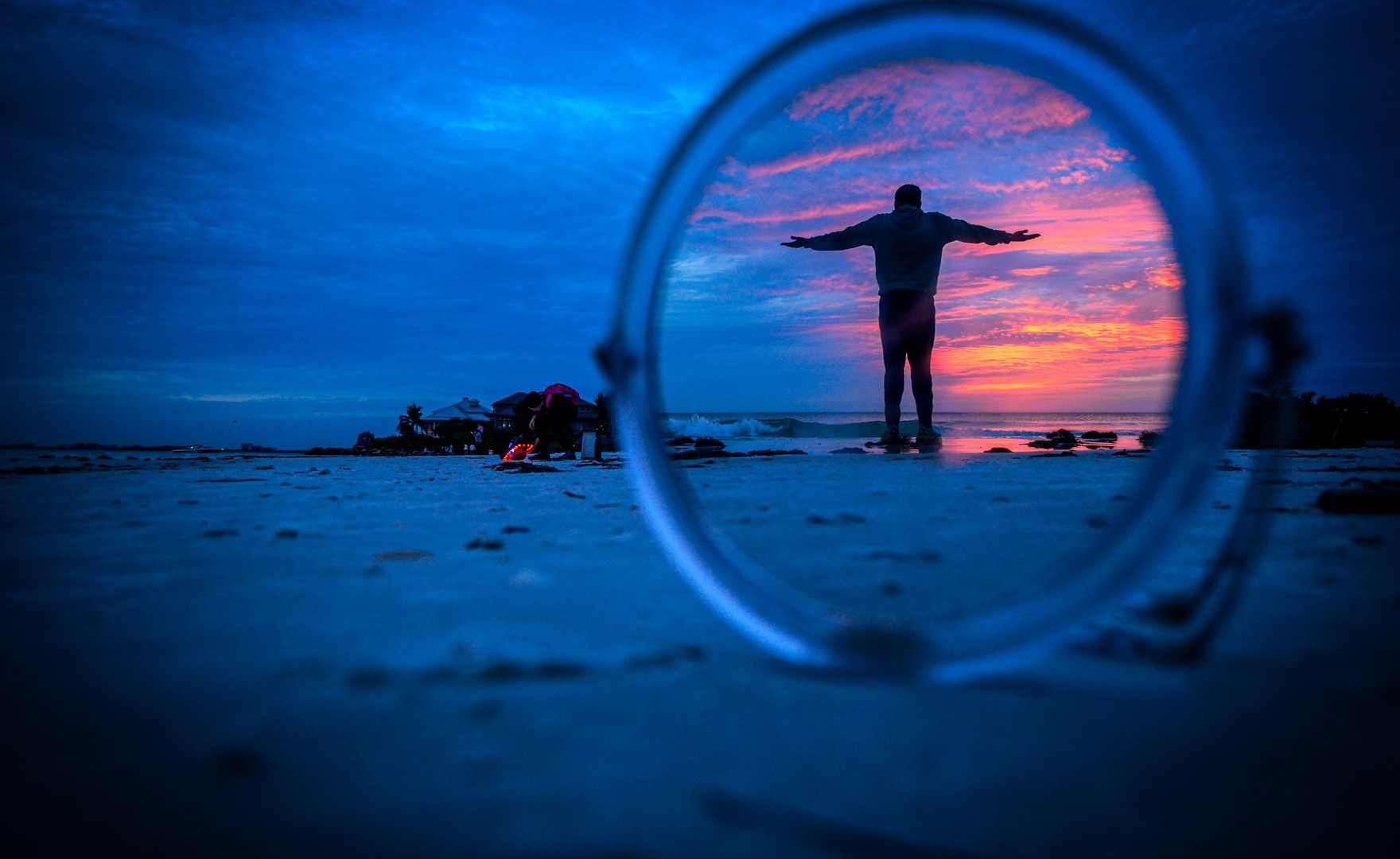 Image of man standing on a beach reflecting