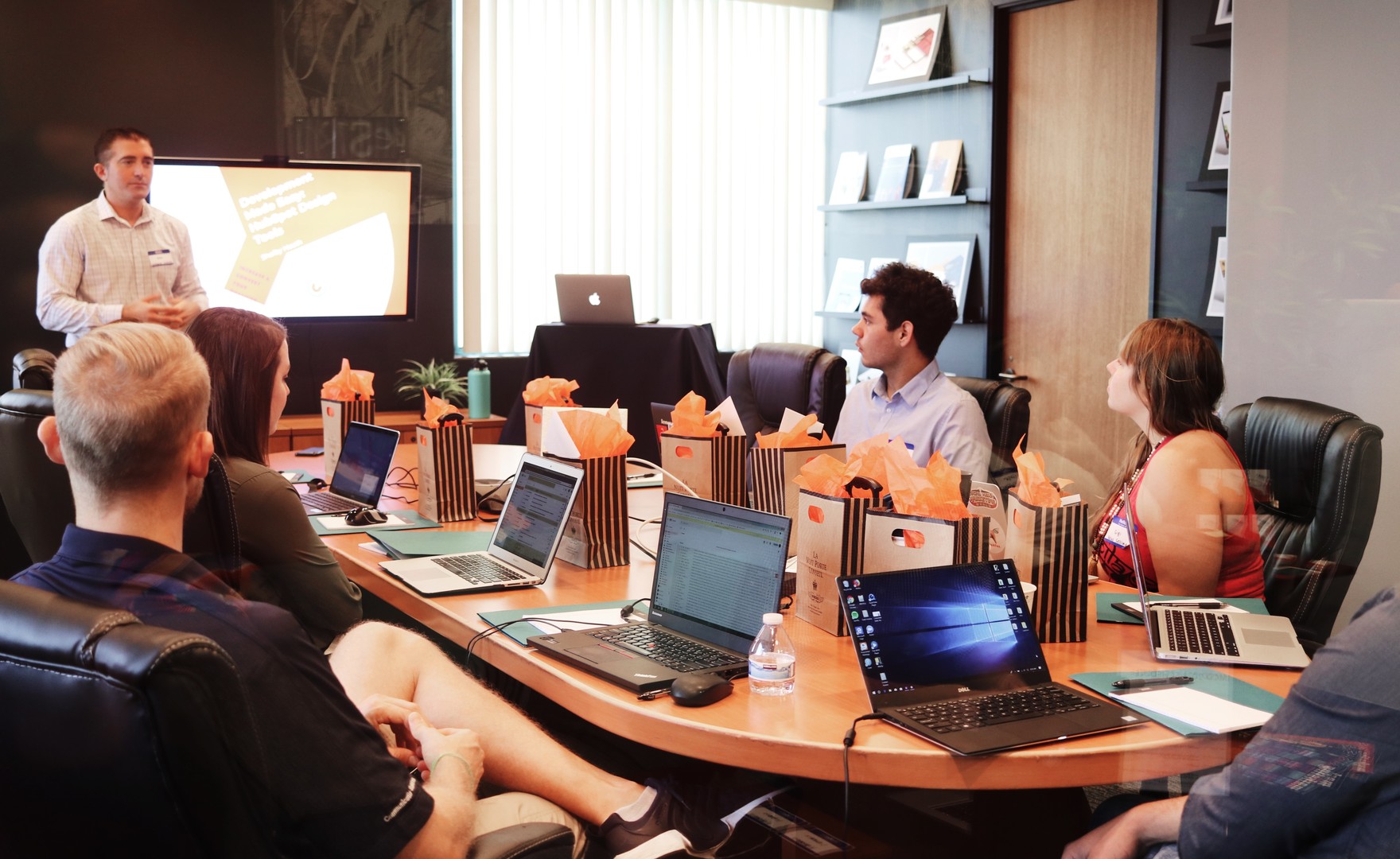 Team in corporate boardroom setting watching a presentation