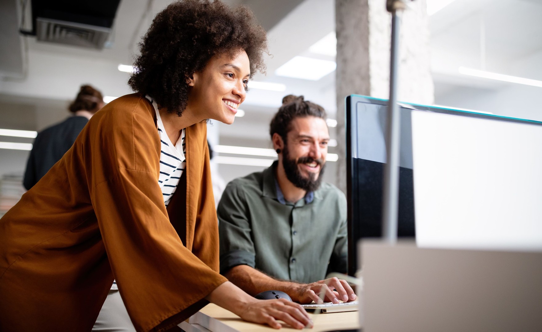 Photo of work colleagues at a computer together