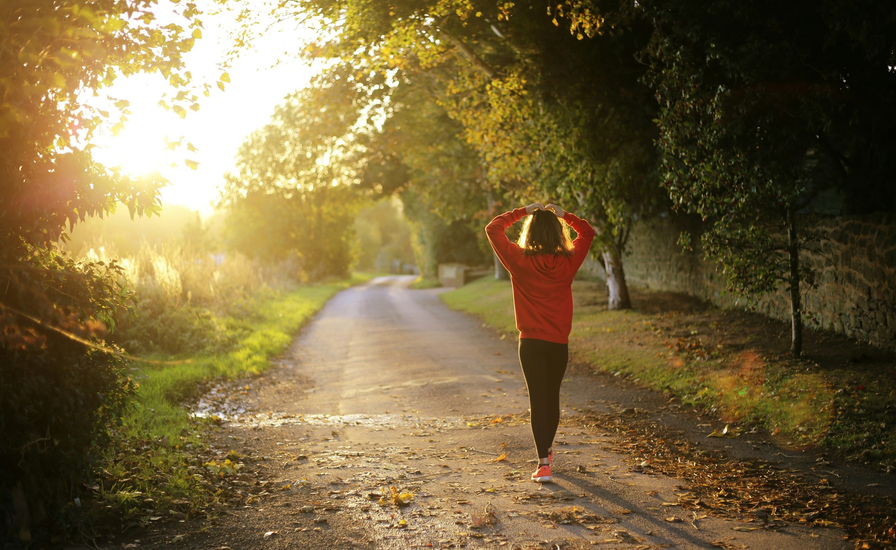 Photo of woman walking alone on country lane