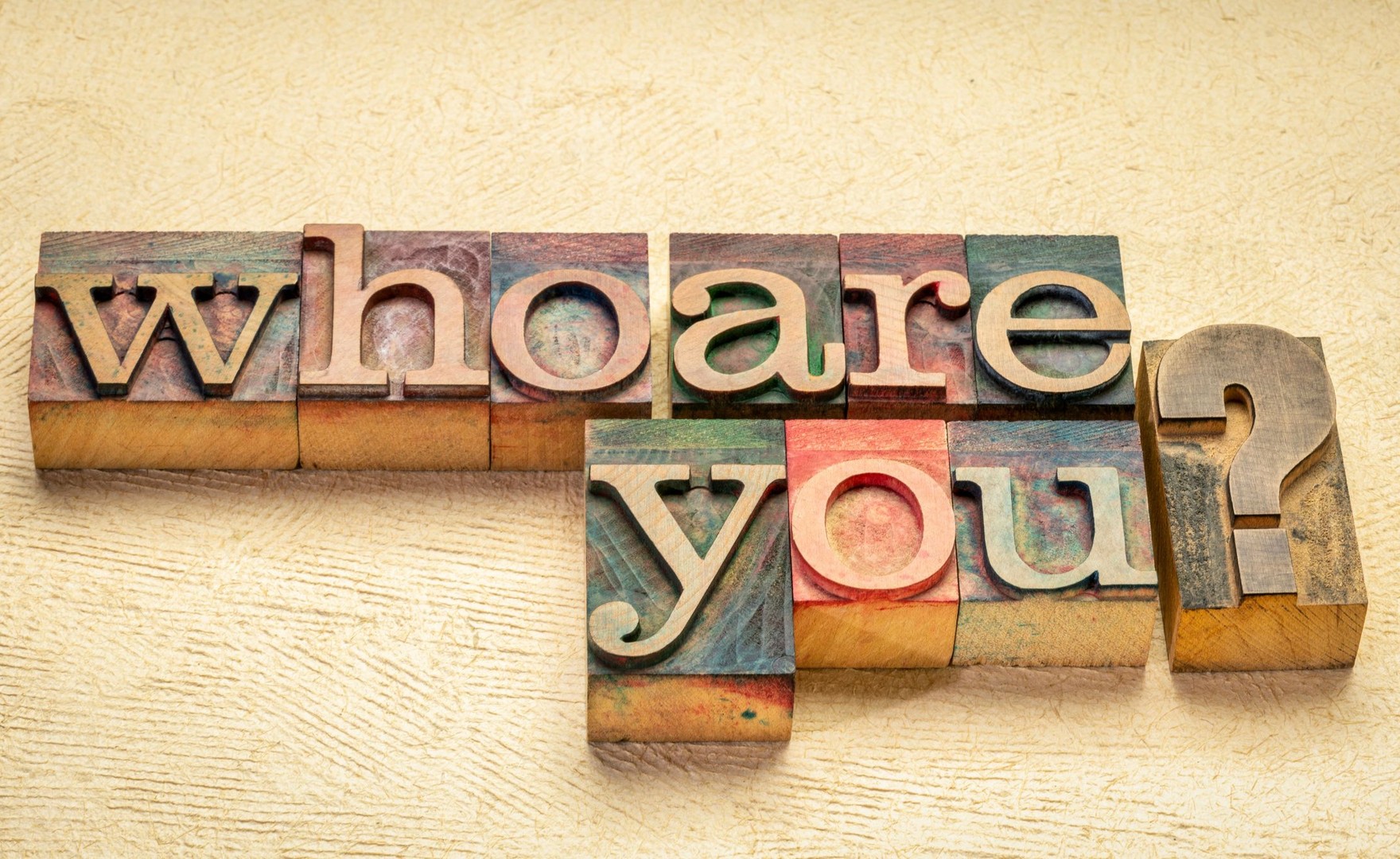 Wooden blocks in different colours which read out 'who are you?'